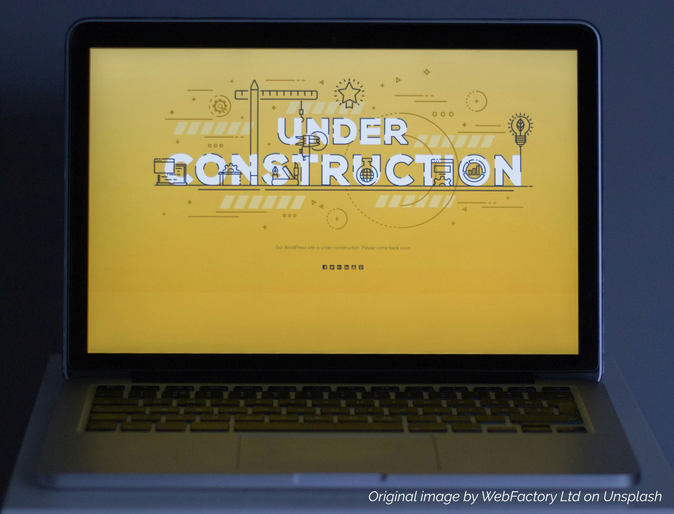 A laptop showing an under-construction page created with a WordPress plugin
